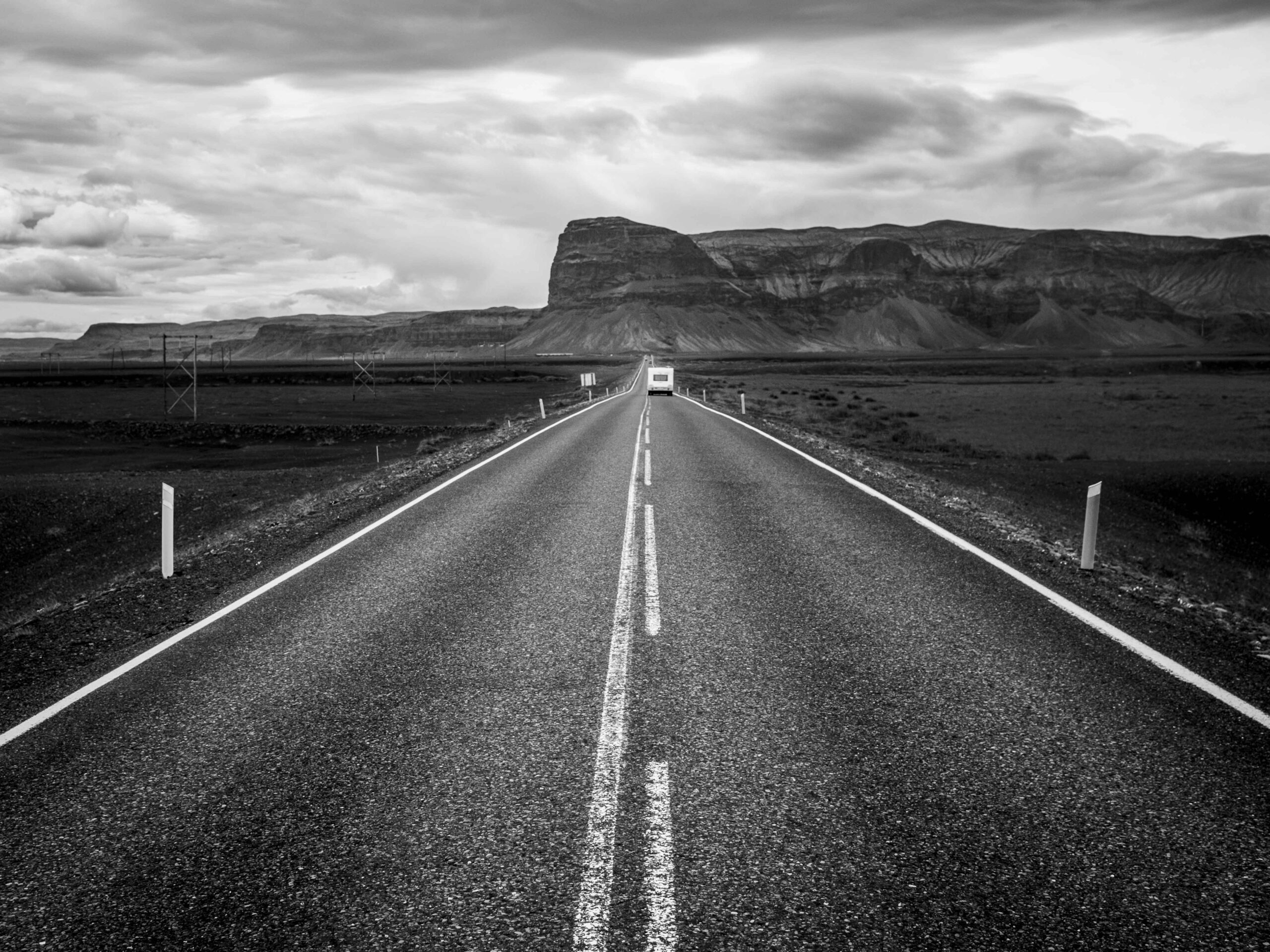 A straight road towards a table mountain
