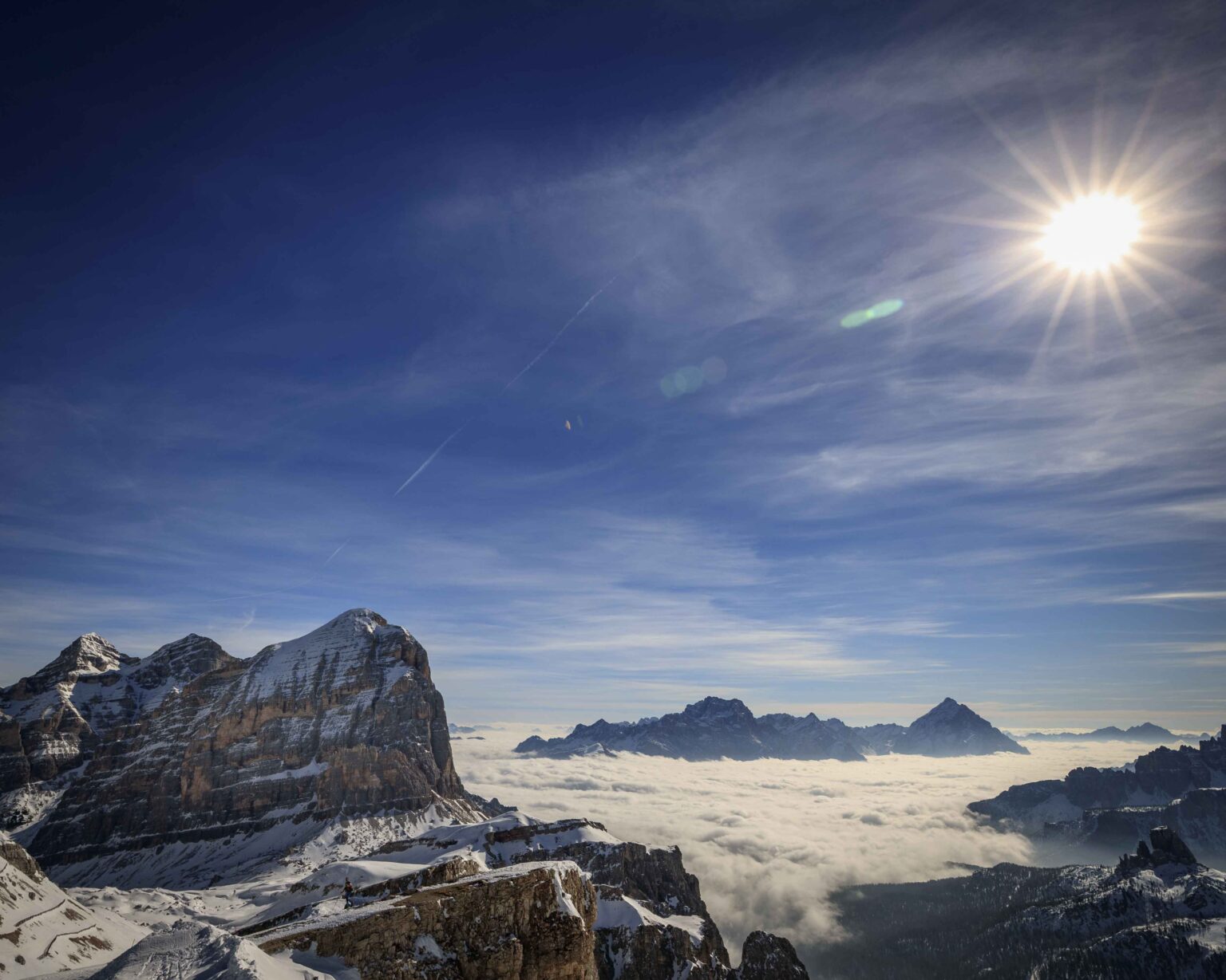 Sun above a sea of cloud and peaks